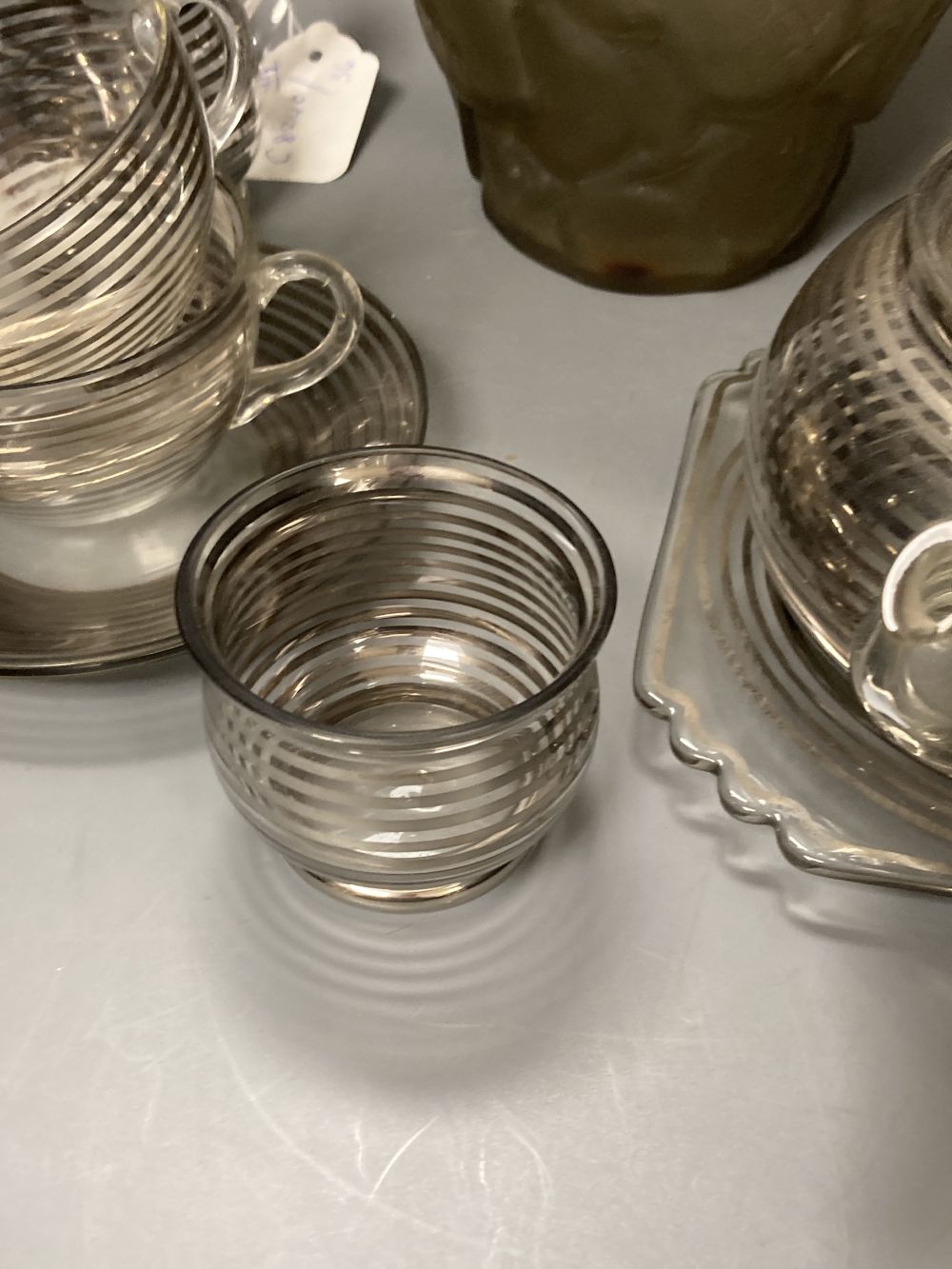 An Art Deco silver stripe and glass tea for two and a frosted leaf design vase, 23.5cm